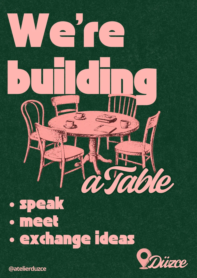 Atelier afişi: We're building a Table. Pembe bir masa etrafında farklı sandalyeler; speak, meet, exchange ideas.